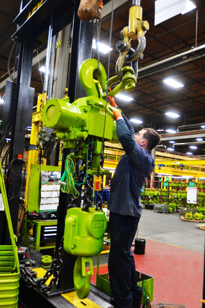 worker uses a LGH test stand to test a piece of equipment 