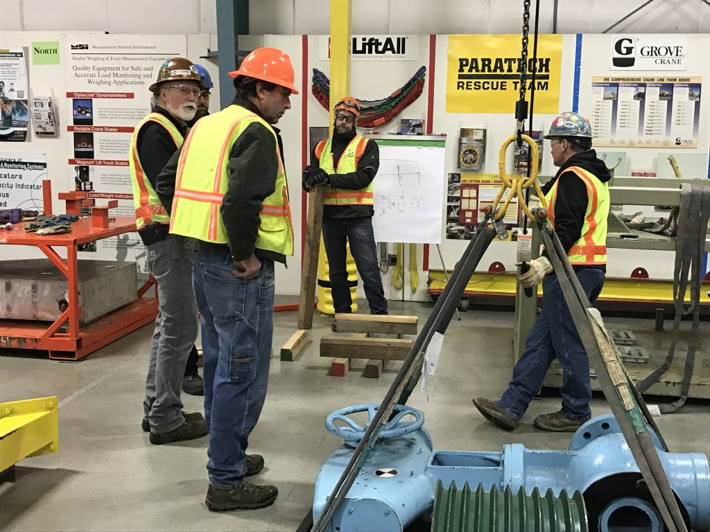 workers dressed in safety gear talking during an ITI Masters Riggers conference 